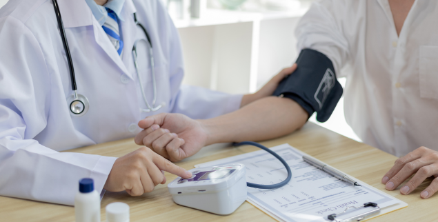 Patient getting blood pressure taken by doctor